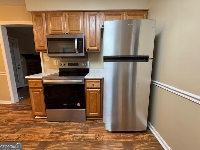 kitchen with dark wood-type flooring and stainless steel appliances