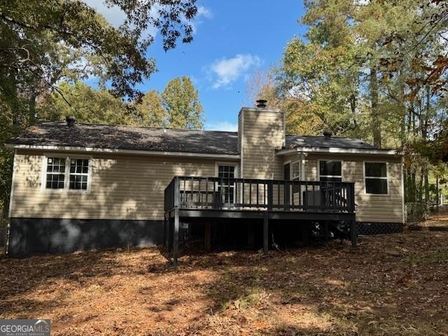 rear view of house with a wooden deck