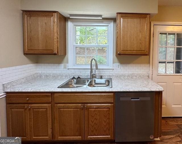 kitchen featuring tasteful backsplash, sink, and dishwasher