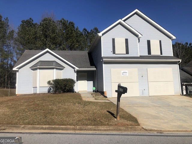 view of property with a garage and a front yard