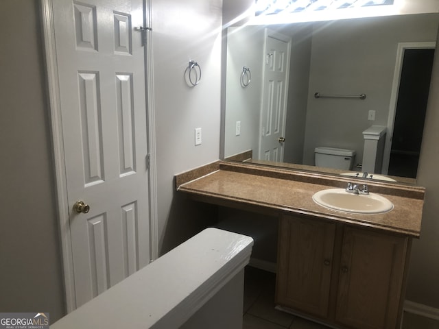 bathroom with vanity, tile patterned floors, and toilet