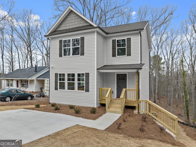 view of front of property featuring a shingled roof