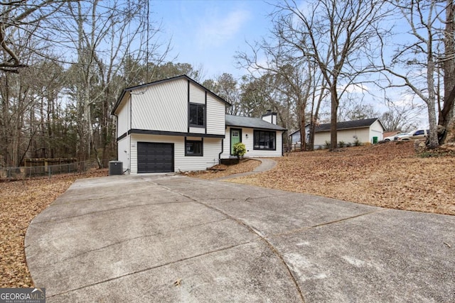 tri-level home with cooling unit and a garage