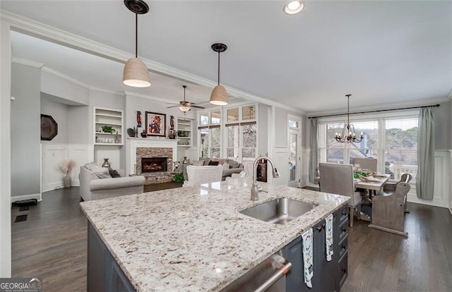 kitchen featuring ornamental molding, sink, and pendant lighting