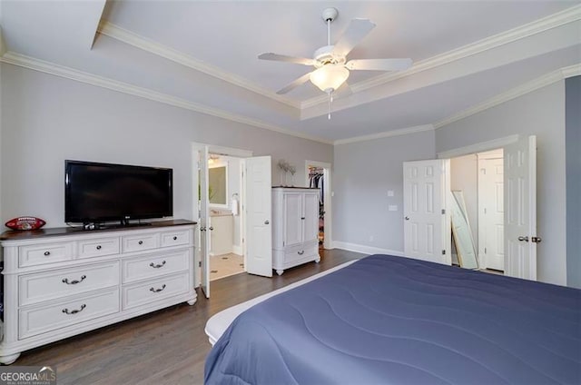 bedroom featuring ensuite bathroom, ceiling fan, a raised ceiling, crown molding, and dark wood-type flooring