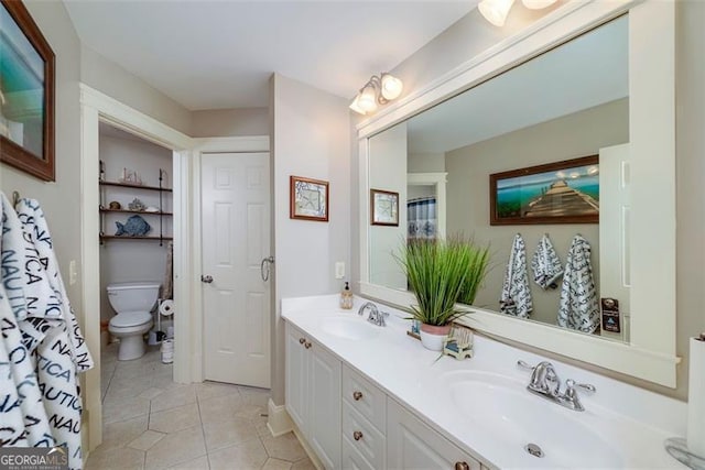 bathroom featuring vanity, toilet, and tile patterned flooring