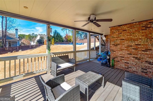 wooden terrace featuring ceiling fan