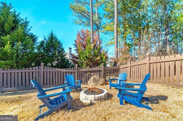 view of yard with a fire pit