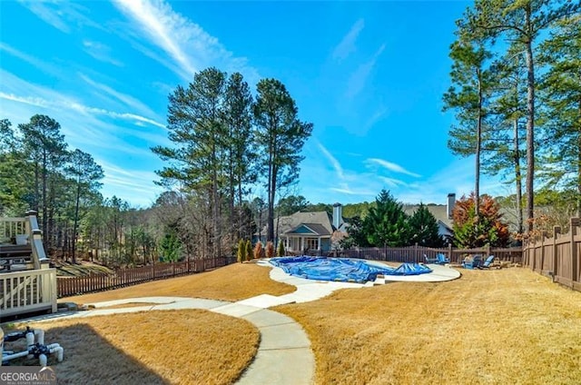 view of swimming pool with a yard