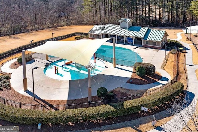 view of swimming pool with a water slide and a patio