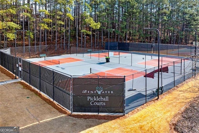 view of sport court with basketball hoop