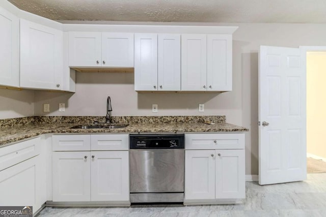 kitchen with white cabinetry, dishwasher, sink, and dark stone countertops