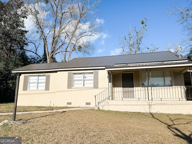 ranch-style house with a front yard and covered porch