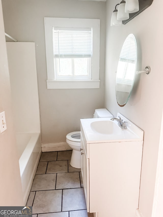 bathroom featuring vanity, tile patterned floors, and toilet