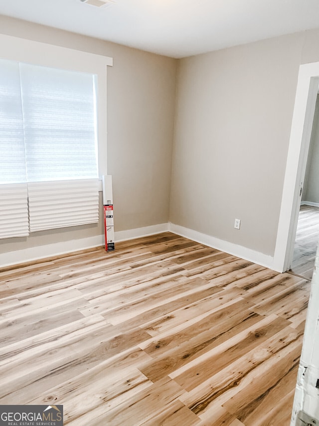 spare room featuring light wood-type flooring