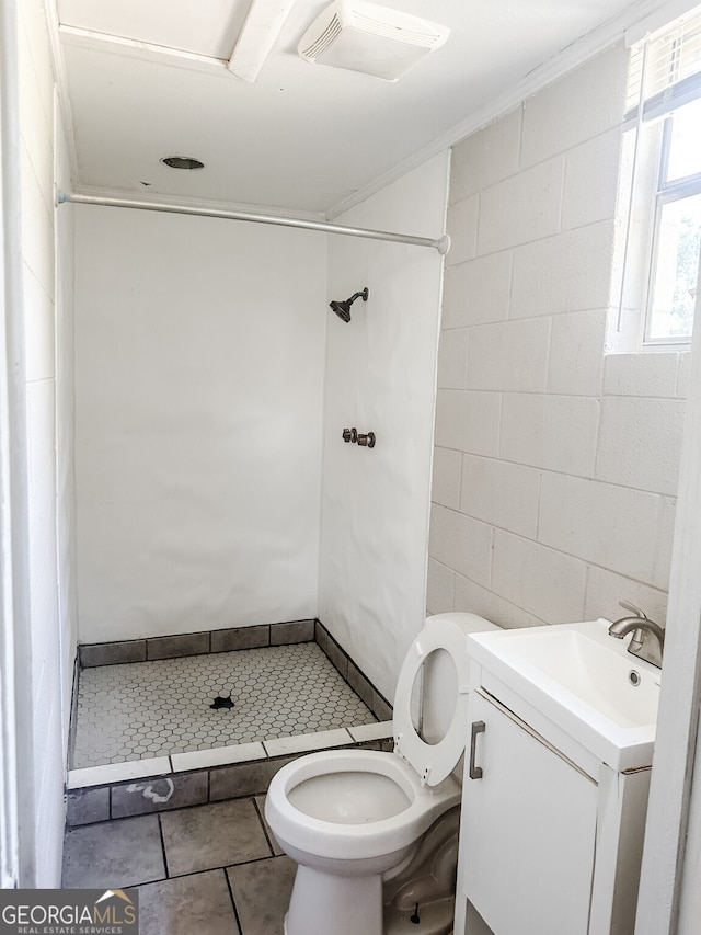 bathroom featuring crown molding, tile patterned flooring, vanity, a shower, and toilet