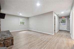 unfurnished living room featuring light hardwood / wood-style flooring