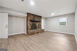 unfurnished living room featuring hardwood / wood-style flooring and a fireplace