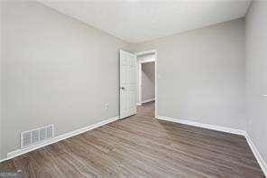 unfurnished room featuring dark wood-type flooring