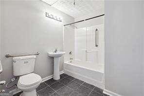 full bathroom with tub / shower combination, sink, and toilet