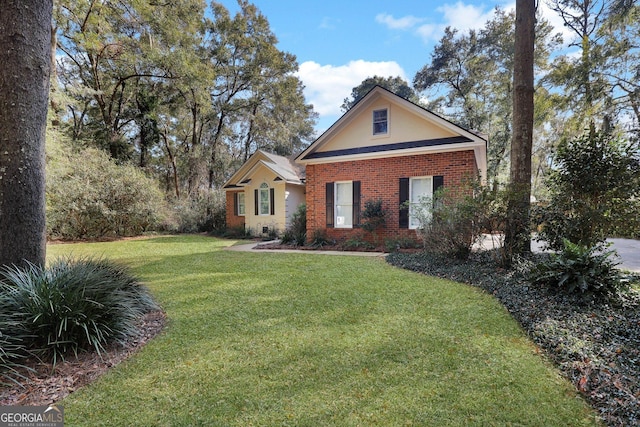 view of front facade with brick siding, stucco siding, and a front lawn