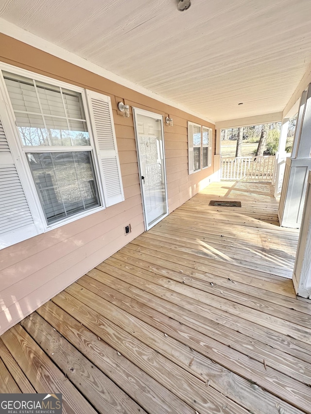 wooden terrace with a porch