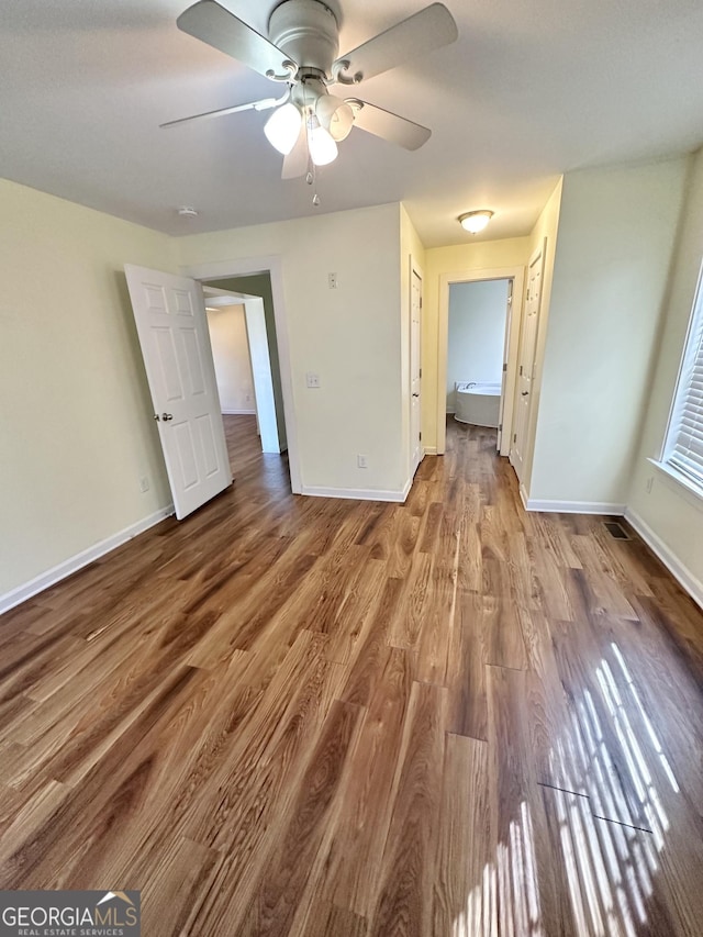 unfurnished bedroom with wood-type flooring, a closet, and ceiling fan