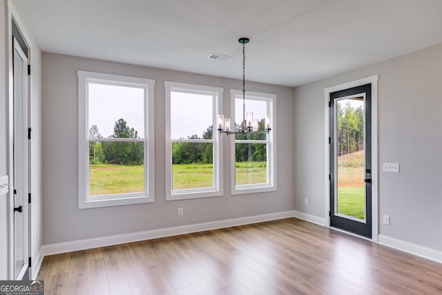 1611 Bethesda Church Rd, Carrollton, GA 30117 - unfurnished dining area featuring a chandelier and wood finished floors