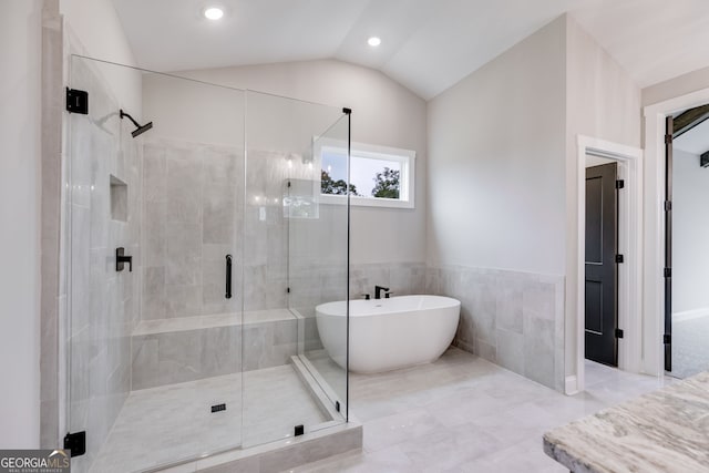 1611 Bethesda Church Rd, Carrollton, GA 30117 - full bathroom with a shower stall, a freestanding bath, tile walls, lofted ceiling, and recessed lighting