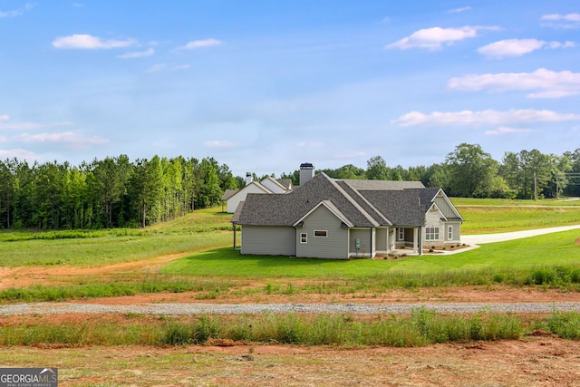 1611 Bethesda Church Rd, Carrollton, GA 30117 - view of home's exterior with a chimney, roof with shingles, and a yard