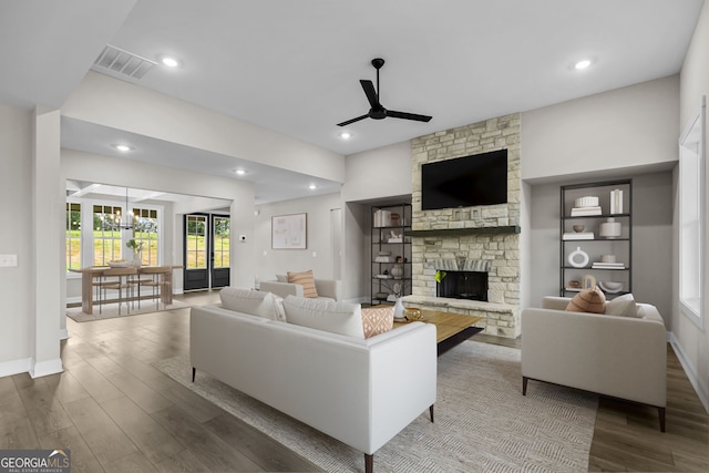 1611 Bethesda Church Rd, Carrollton, GA 30117 - living room featuring ceiling fan, wood finished floors, a stone fireplace, a chandelier, and recessed lighting
