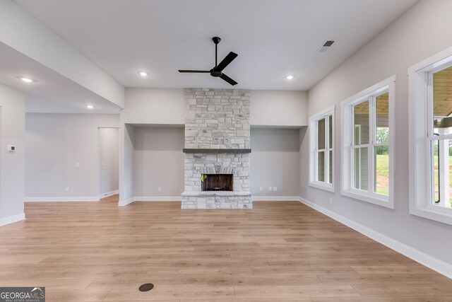 1611 Bethesda Church Rd, Carrollton, GA 30117 - unfurnished living room with ceiling fan, light wood-style flooring, a stone fireplace, and recessed lighting