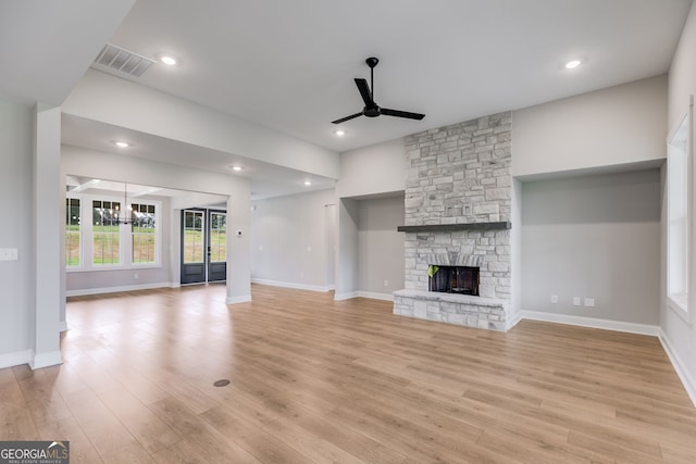 1611 Bethesda Church Rd, Carrollton, GA 30117 - unfurnished living room featuring a ceiling fan, a chandelier, light wood-type flooring, a fireplace, and recessed lighting