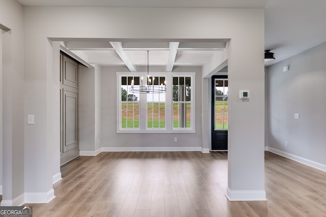 1611 Bethesda Church Rd, Carrollton, GA 30117 - unfurnished dining area with healthy amount of natural light, coffered ceiling, a chandelier, beam ceiling, and light wood-style flooring