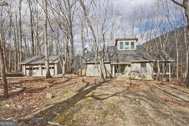 view of front of house featuring a garage and an outdoor structure