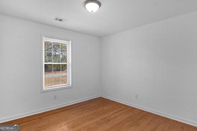 spare room featuring hardwood / wood-style floors