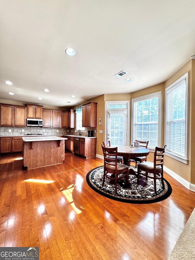 dining space with hardwood / wood-style floors and sink