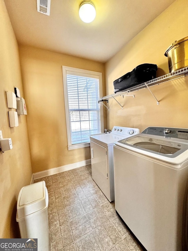 washroom with independent washer and dryer