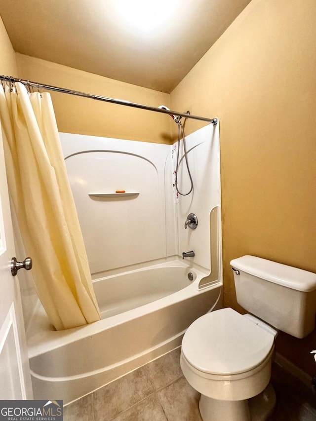 bathroom featuring toilet, tile patterned floors, and shower / bath combo with shower curtain