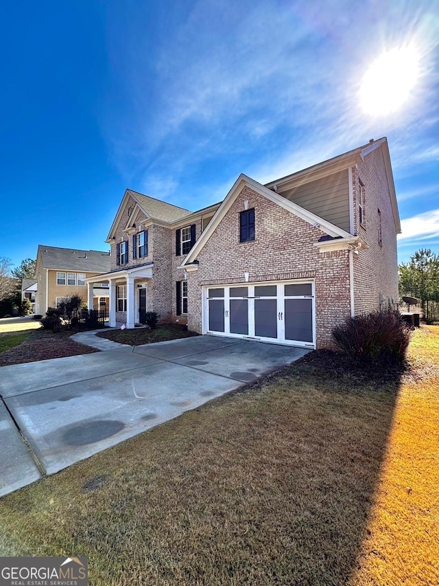 view of front of home with a garage and a front lawn