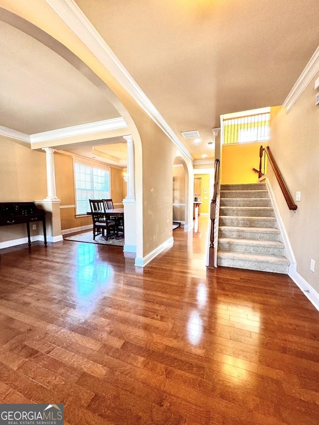 interior space with hardwood / wood-style floors and crown molding