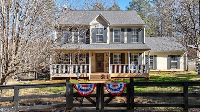 view of front facade with covered porch and a fenced front yard