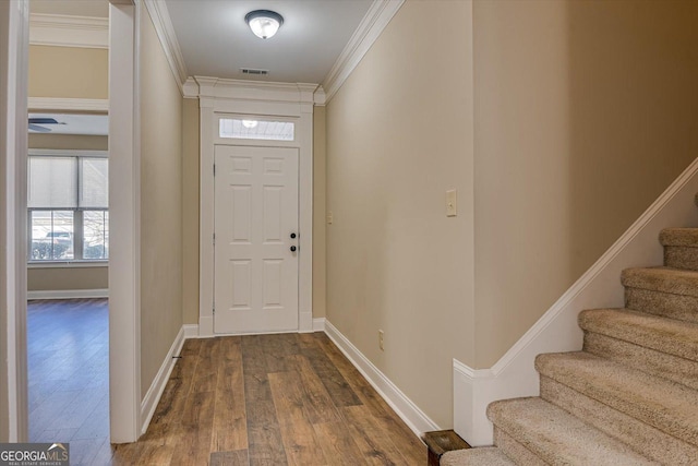 foyer featuring hardwood / wood-style floors and ornamental molding