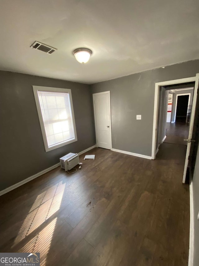 spare room featuring dark hardwood / wood-style floors