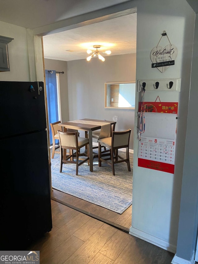 dining space with hardwood / wood-style flooring