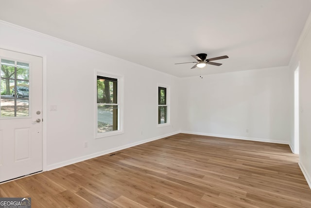 entryway featuring hardwood / wood-style flooring, ornamental molding, and ceiling fan