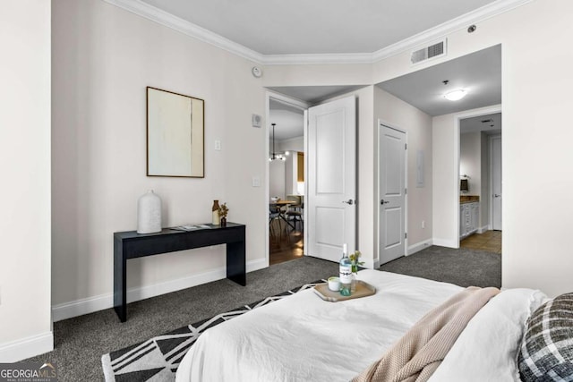 bedroom with ornamental molding and dark colored carpet