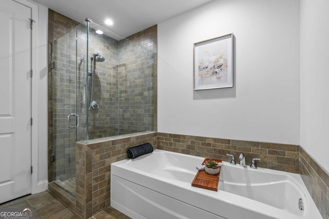 bathroom with tile patterned floors and shower with separate bathtub