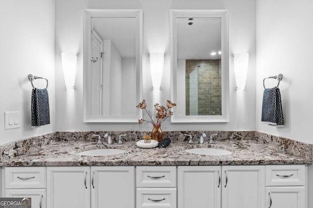 bathroom featuring walk in shower and vanity