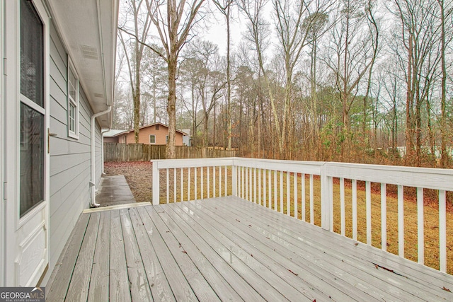 wooden deck with a lawn